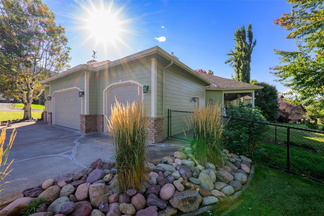 8785 Jacot Ln, Missoula, MT 59808 - view of side of property with an attached garage and concrete driveway
