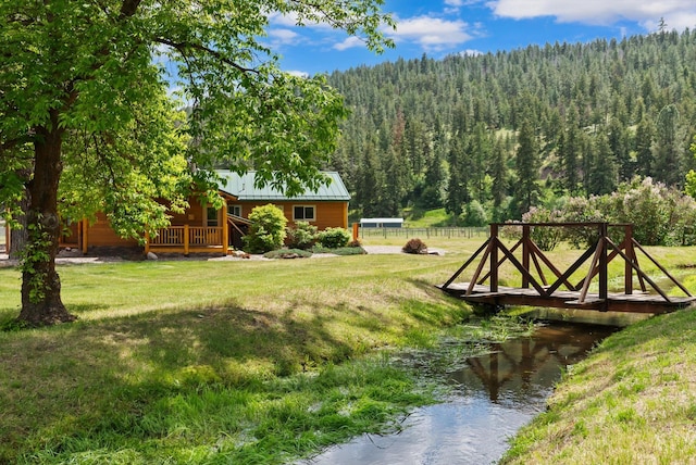 3005 Big Flat Rd, Missoula, MT 59804 - view of yard with a forest view and a wooden deck
