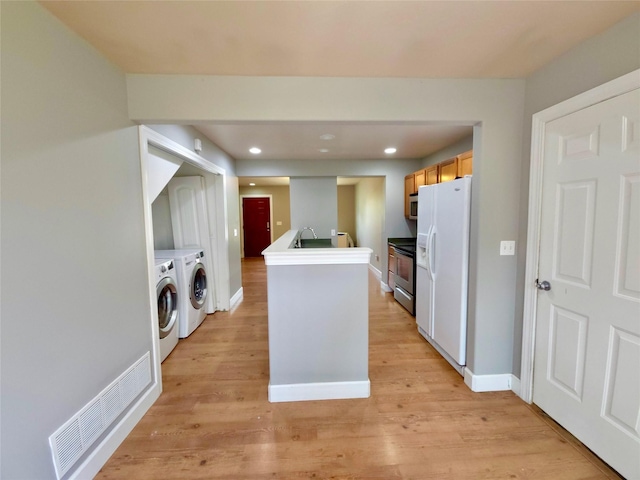 1109 Wyoming St, Belgrade, MT 59714 - kitchen with white appliances, washing machine and dryer, recessed lighting, and light wood-type flooring
