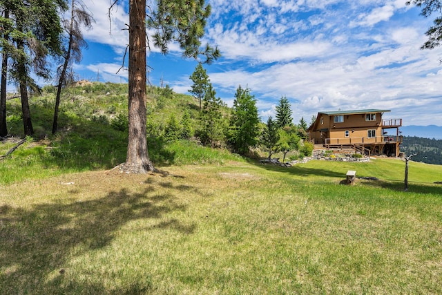 298 Lone Wolf Trl, Lakeside, MT 59922 - view of green lawn with a deck