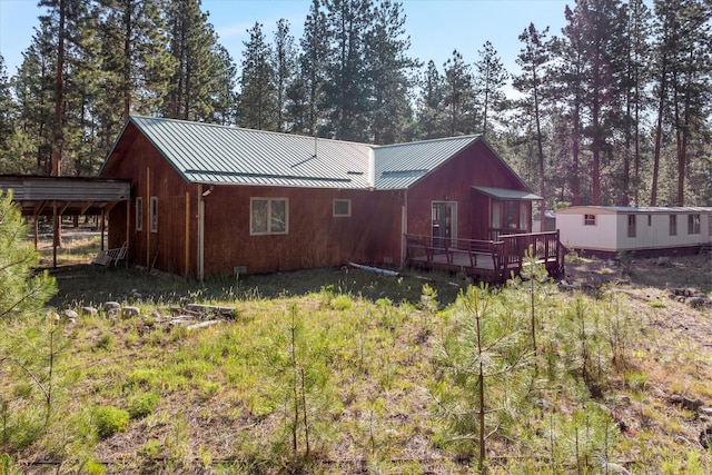 452 Blair Ln, Victor, MT 59875 - back of house featuring a standing seam roof, a wooden deck, and a metal roof