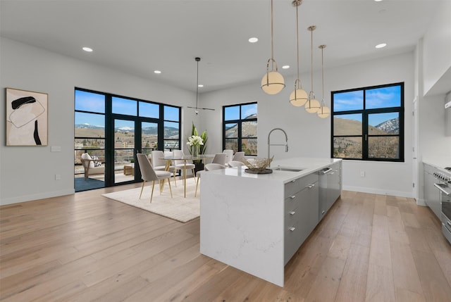 265 S 4th St E Unit 405, Missoula, MT 59801 - kitchen featuring recessed lighting, light wood-type flooring, light countertops, stainless steel dishwasher, and a kitchen island with sink