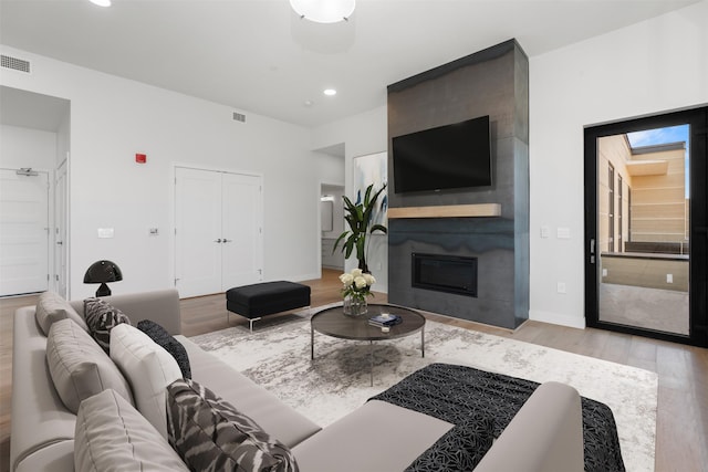 265 S 4th St E Unit 405, Missoula, MT 59801 - living room featuring wood finished floors, recessed lighting, and a fireplace
