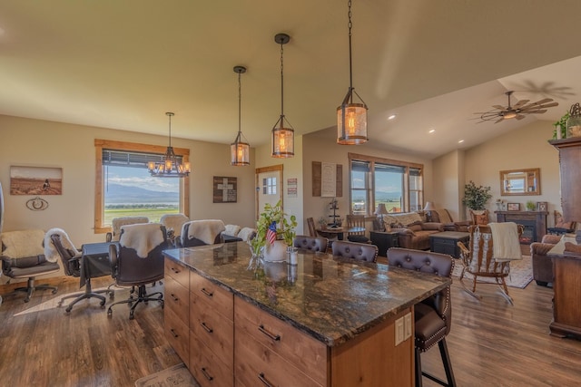51 Whitehorse Rd, Townsend, MT 59644 - kitchen featuring a breakfast bar area, dark wood-type flooring, open floor plan, a chandelier, and vaulted ceiling