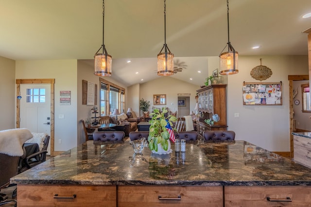 51 Whitehorse Rd, Townsend, MT 59644 - kitchen with open floor plan, vaulted ceiling, recessed lighting, brown cabinets, and pendant lighting