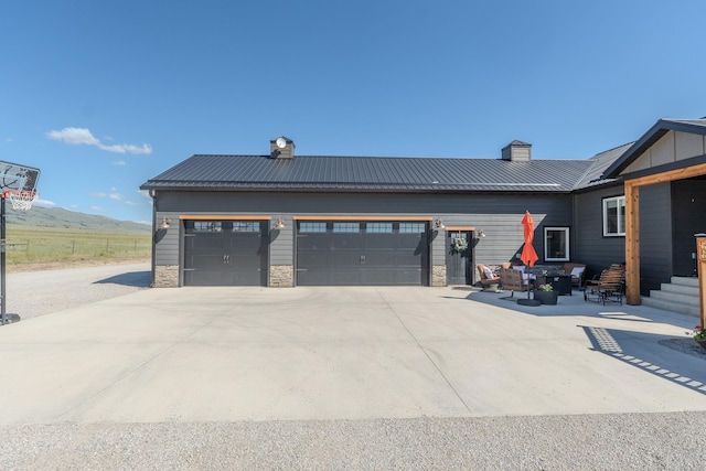 51 Whitehorse Rd, Townsend, MT 59644 - view of property exterior with a chimney, concrete driveway, and a metal roof