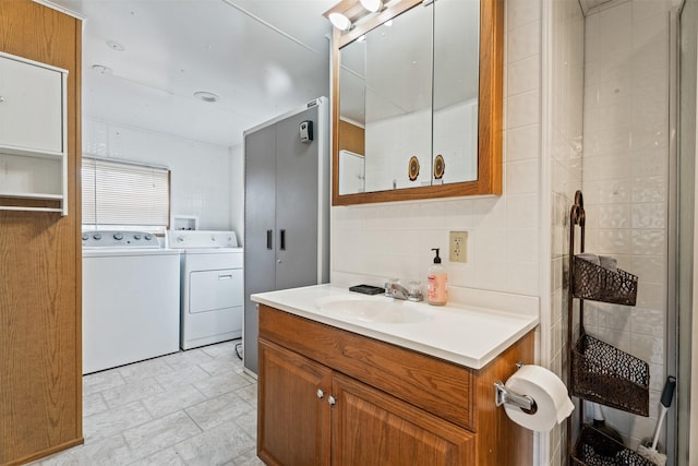 752 Grizzly Dr, Seeley Lake, MT 59868 - bathroom with washer and dryer, vanity, a garden tub, a tile shower, and backsplash