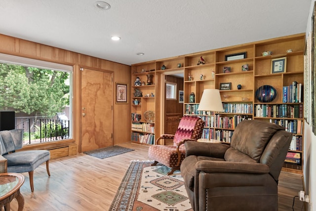 1700 Arthur Ave, Missoula, MT 59801 - sitting room featuring wood finished floors, a textured ceiling, wood walls, and recessed lighting