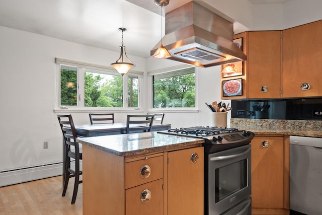 1700 Arthur Ave, Missoula, MT 59801 - kitchen featuring island range hood, appliances with stainless steel finishes, healthy amount of natural light, and light wood finished floors