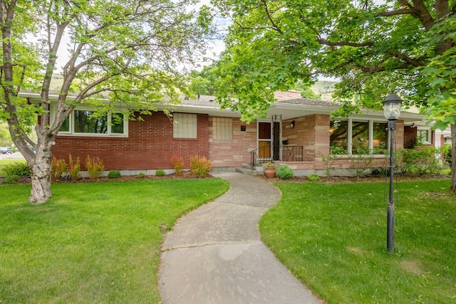 1700 Arthur Ave, Missoula, MT 59801 - ranch-style house with a front yard, brick siding, roof with shingles, and stone siding
