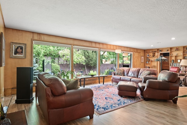 1700 Arthur Ave, Missoula, MT 59801 - living area with a textured ceiling, healthy amount of natural light, wood finished floors, wood walls, and recessed lighting