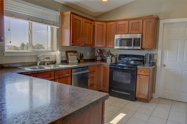 3250 Stillwell Dr, Helena, MT 59602 - kitchen with appliances with stainless steel finishes, brown cabinets, light tile patterned floors, lofted ceiling, and dark countertops