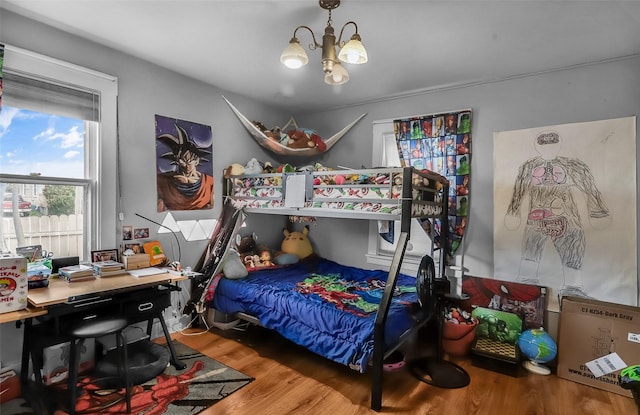 1126 4th Ave S, Great Falls, MT 59405 - bedroom with wood finished floors, a chandelier, and a desk