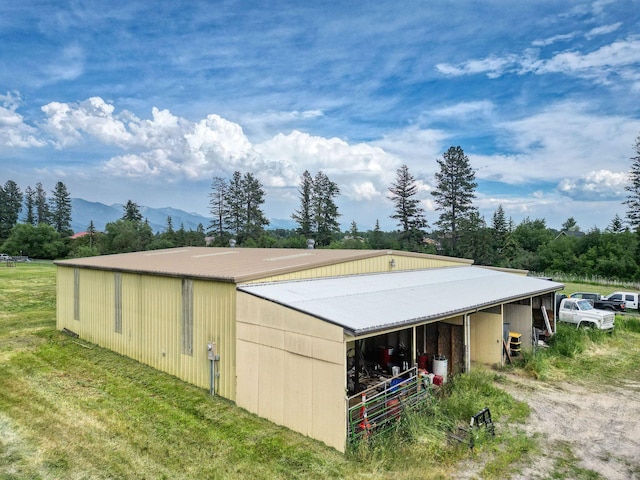 791 Springwood Ln, Kalispell, MT 59901 - view of side of property with an outdoor structure, a mountain view, and an exterior structure