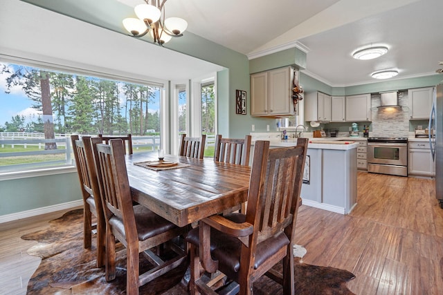 791 Springwood Ln, Kalispell, MT 59901 - dining room with a chandelier, light wood-style flooring, and vaulted ceiling