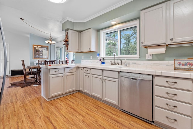 791 Springwood Ln, Kalispell, MT 59901 - kitchen featuring dishwasher, light wood-style floors, a peninsula, a chandelier, and ornamental molding