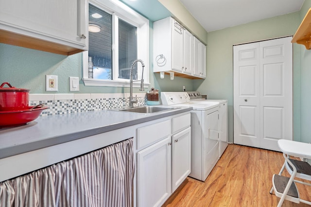 791 Springwood Ln, Kalispell, MT 59901 - laundry room featuring independent washer and dryer, cabinet space, and light wood-type flooring