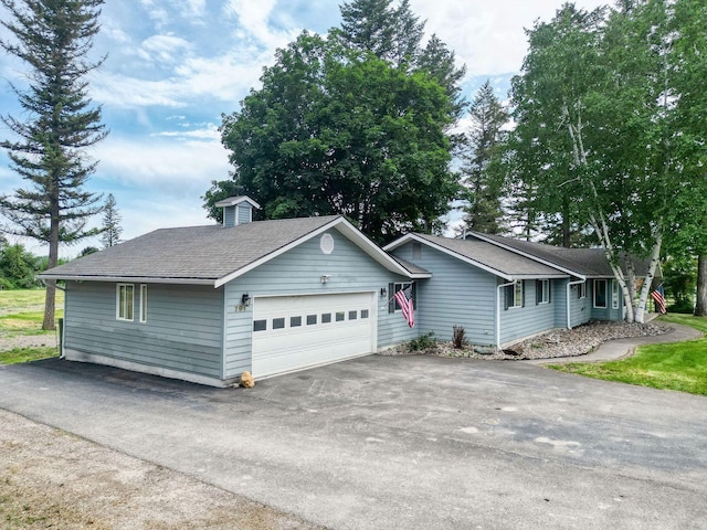 791 Springwood Ln, Kalispell, MT 59901 - ranch-style house featuring asphalt driveway, an attached garage, and roof with shingles