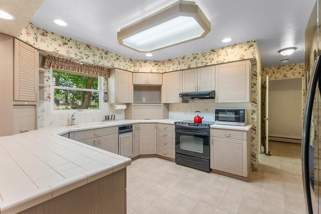 1229 Old Orchard Rd, Missoula, MT 59802 - kitchen with black / electric stove, stainless steel microwave, a baseboard radiator, under cabinet range hood, and tile countertops