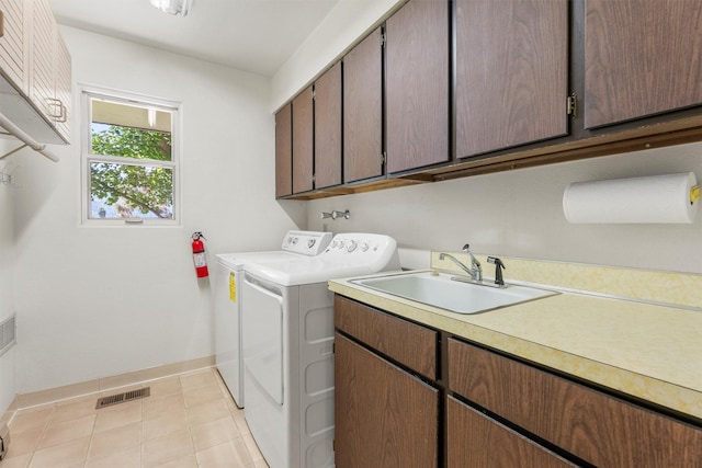 1229 Old Orchard Rd, Missoula, MT 59802 - washroom with cabinet space, washer and dryer, and light tile patterned flooring