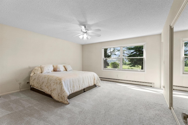 1229 Old Orchard Rd, Missoula, MT 59802 - bedroom with a baseboard heating unit, carpet, a ceiling fan, and a textured ceiling
