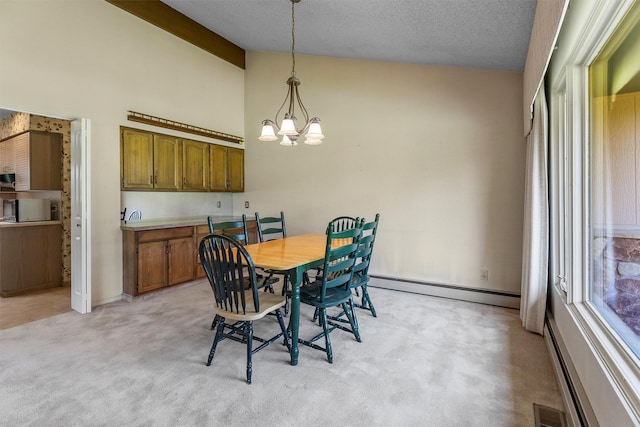 1229 Old Orchard Rd, Missoula, MT 59802 - dining space featuring a baseboard heating unit, a chandelier, light colored carpet, and high vaulted ceiling