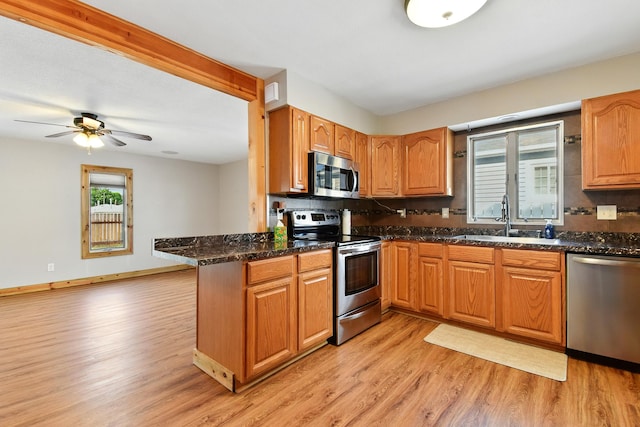 3121 6th Ave S, Great Falls, MT 59405 - kitchen featuring appliances with stainless steel finishes, light wood finished floors, decorative backsplash, and ceiling fan