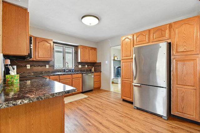 3121 6th Ave S, Great Falls, MT 59405 - kitchen featuring appliances with stainless steel finishes, light wood-type flooring, and decorative backsplash