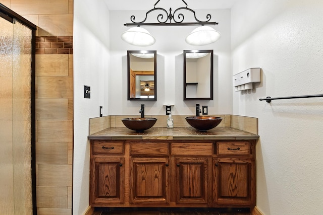 3121 6th Ave S, Great Falls, MT 59405 - full bath featuring double vanity, a tile shower, and a textured wall