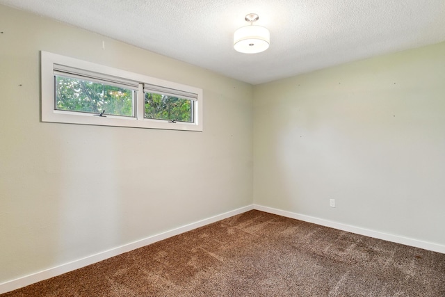 3121 6th Ave S, Great Falls, MT 59405 - empty room featuring dark carpet and a textured ceiling