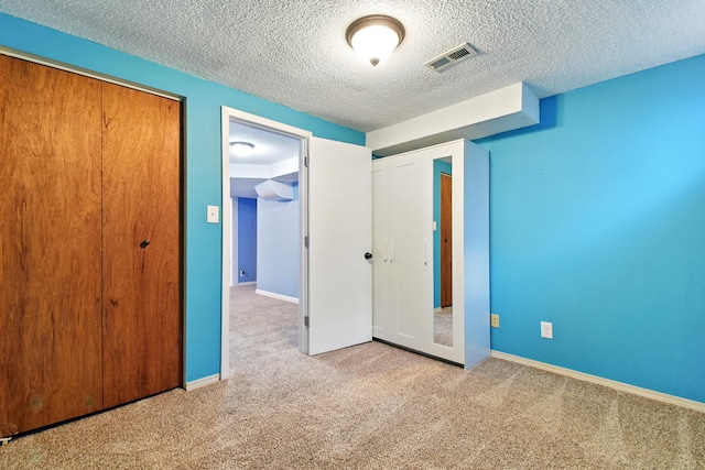 3121 6th Ave S, Great Falls, MT 59405 - unfurnished bedroom with carpet floors, a closet, and a textured ceiling