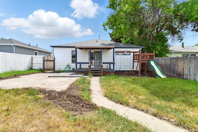 3121 6th Ave S, Great Falls, MT 59405 - rear view of house featuring a fenced backyard, a playground, and a patio