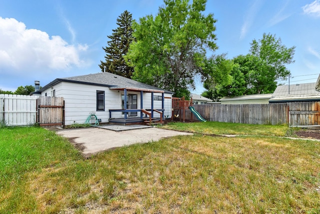 3121 6th Ave S, Great Falls, MT 59405 - back of property with a fenced backyard, a playground, a patio, and a gate