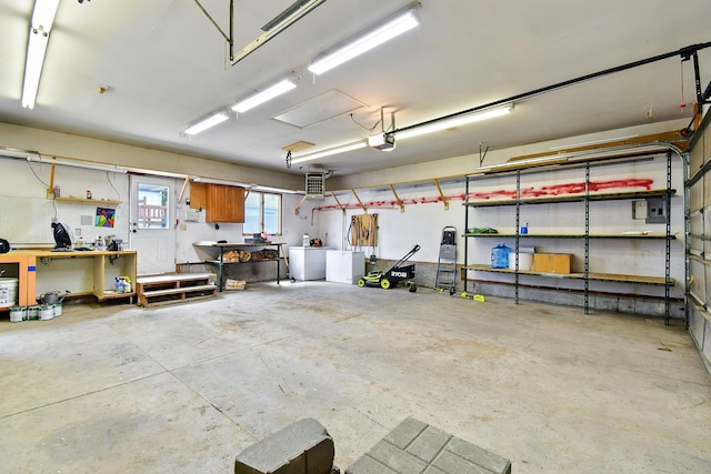 3121 6th Ave S, Great Falls, MT 59405 - garage with a garage door opener, independent washer and dryer, and a workshop area