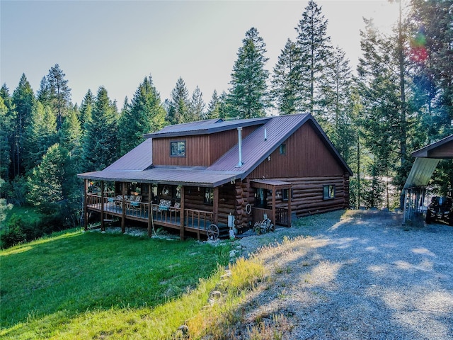 1429 Schoolhouse Lake Rd, Troy, MT 59935 - view of front facade featuring log exterior, covered porch, a metal roof, and a front yard