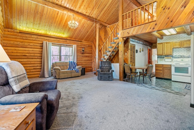 72 Giefer Creek Rd, Essex, MT 59916 - carpeted living room with a chandelier, a wood ceiling with exposed beams, rustic walls, stairs, and high vaulted ceiling