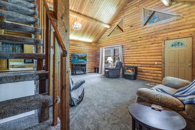 72 Giefer Creek Rd, Essex, MT 59916 - living area with a wood stove, high vaulted ceiling, carpet flooring, log walls, and a wooden ceiling with exposed beams