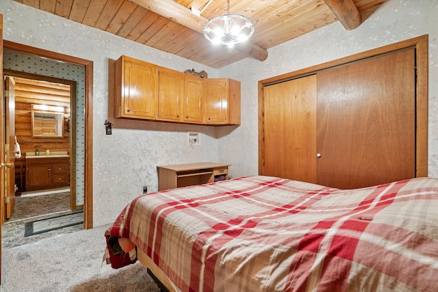 72 Giefer Creek Rd, Essex, MT 59916 - bedroom with carpet floors, a wooden ceiling with exposed beams, a closet, and a textured wall