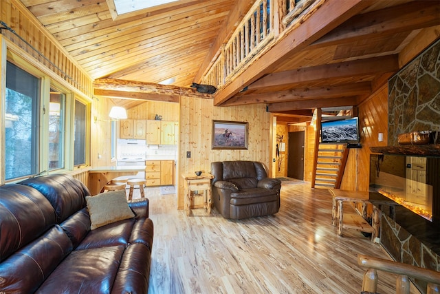 24 Alder Way Unit 3B, Whitefish, MT 59937 - living room featuring wood walls, light wood-style flooring, wood ceiling, stairs, and a skylight