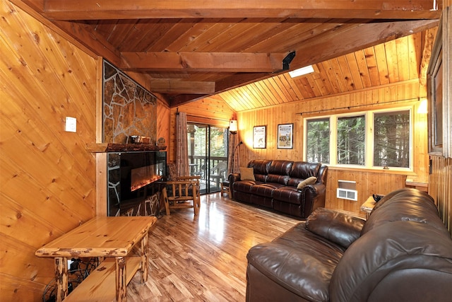 24 Alder Way Unit 3B, Whitefish, MT 59937 - living room with wooden walls, wood ceiling, wood finished floors, and a glass covered fireplace