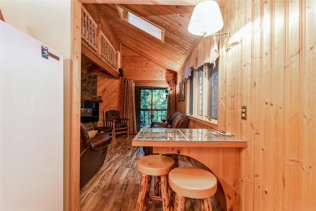 24 Alder Way Unit 3B, Whitefish, MT 59937 - kitchen with wood walls, wood finished floors, wood ceiling, and high vaulted ceiling