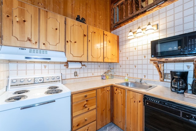 24 Alder Way Unit 3B, Whitefish, MT 59937 - kitchen featuring black appliances, under cabinet range hood, tasteful backsplash, and light countertops