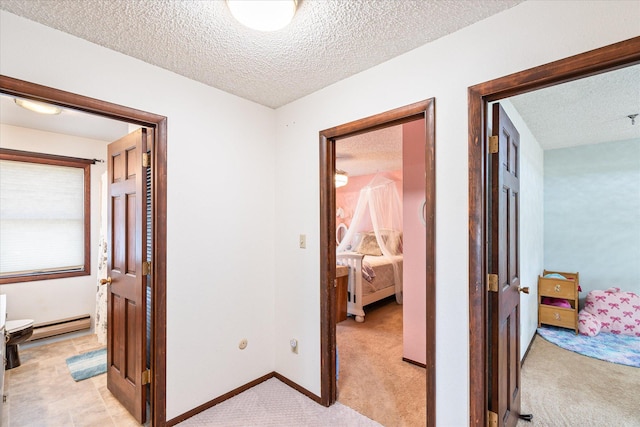 3446 Tizer Dr, Helena, MT 59602 - hall featuring a baseboard radiator, a textured ceiling, and light colored carpet