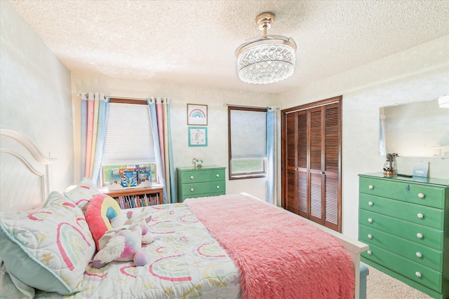 3446 Tizer Dr, Helena, MT 59602 - bedroom featuring a textured ceiling, carpet flooring, and a chandelier
