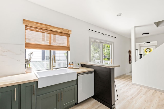 223 12th St N, Great Falls, MT 59401 - kitchen with white dishwasher, plenty of natural light, light wood finished floors, green cabinetry, and recessed lighting
