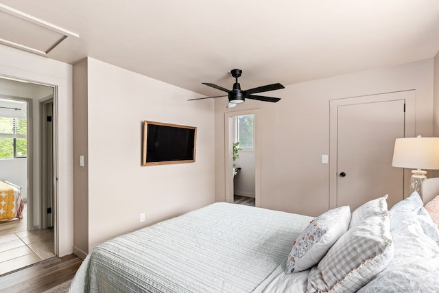 223 12th St N, Great Falls, MT 59401 - bedroom featuring wood finished floors, multiple windows, attic access, and a ceiling fan