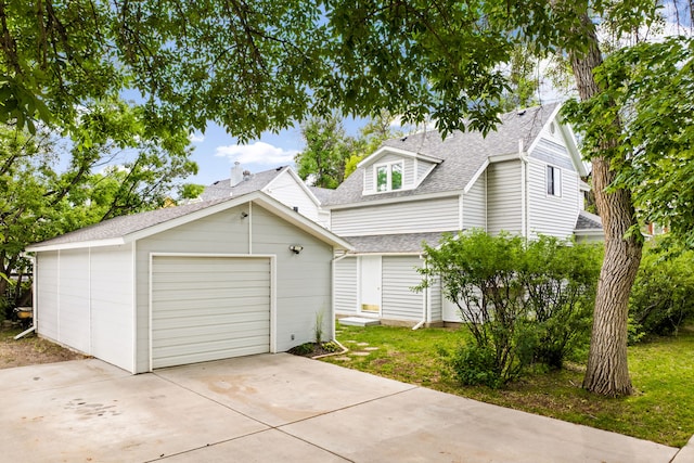223 12th St N, Great Falls, MT 59401 - view of front of property with concrete driveway, an outdoor structure, and a shingled roof