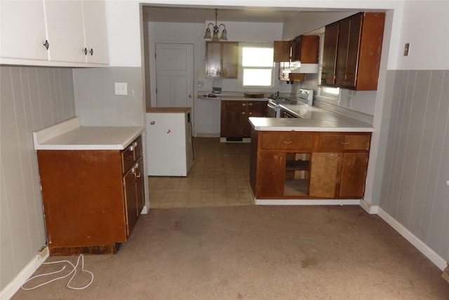 17 Crane Ave, Stockett, MT 59480 - kitchen featuring stainless steel range, under cabinet range hood, light countertops, and white cabinetry