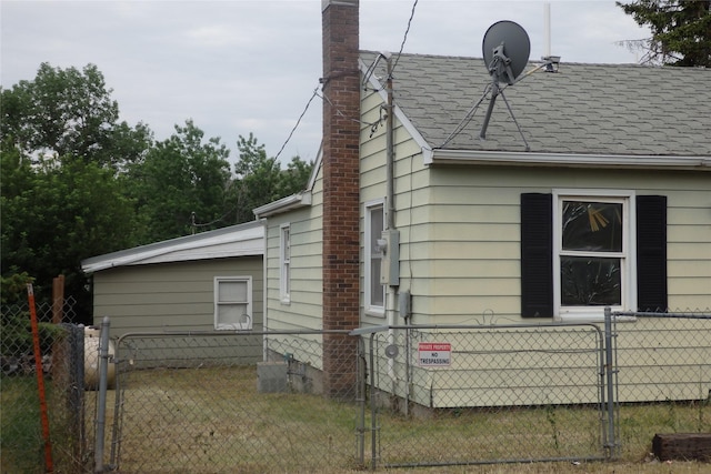 17 Crane Ave, Stockett, MT 59480 - view of side of property with a gate, a chimney, and roof with shingles