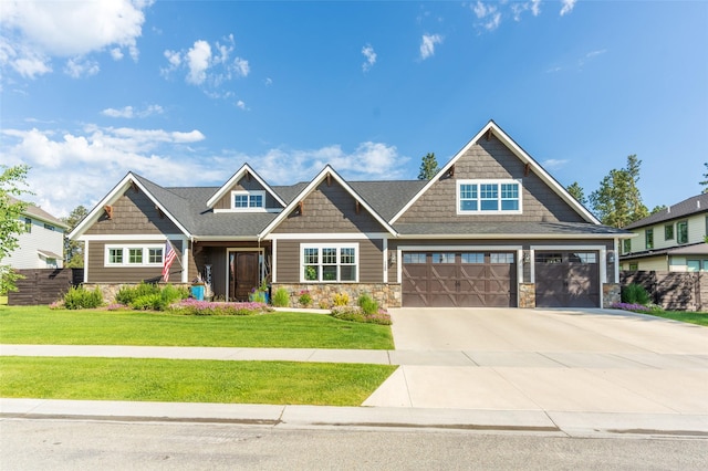 128 Antler Peak Ln, Kalispell, MT 59901 - craftsman-style house with stone siding, driveway, and a garage